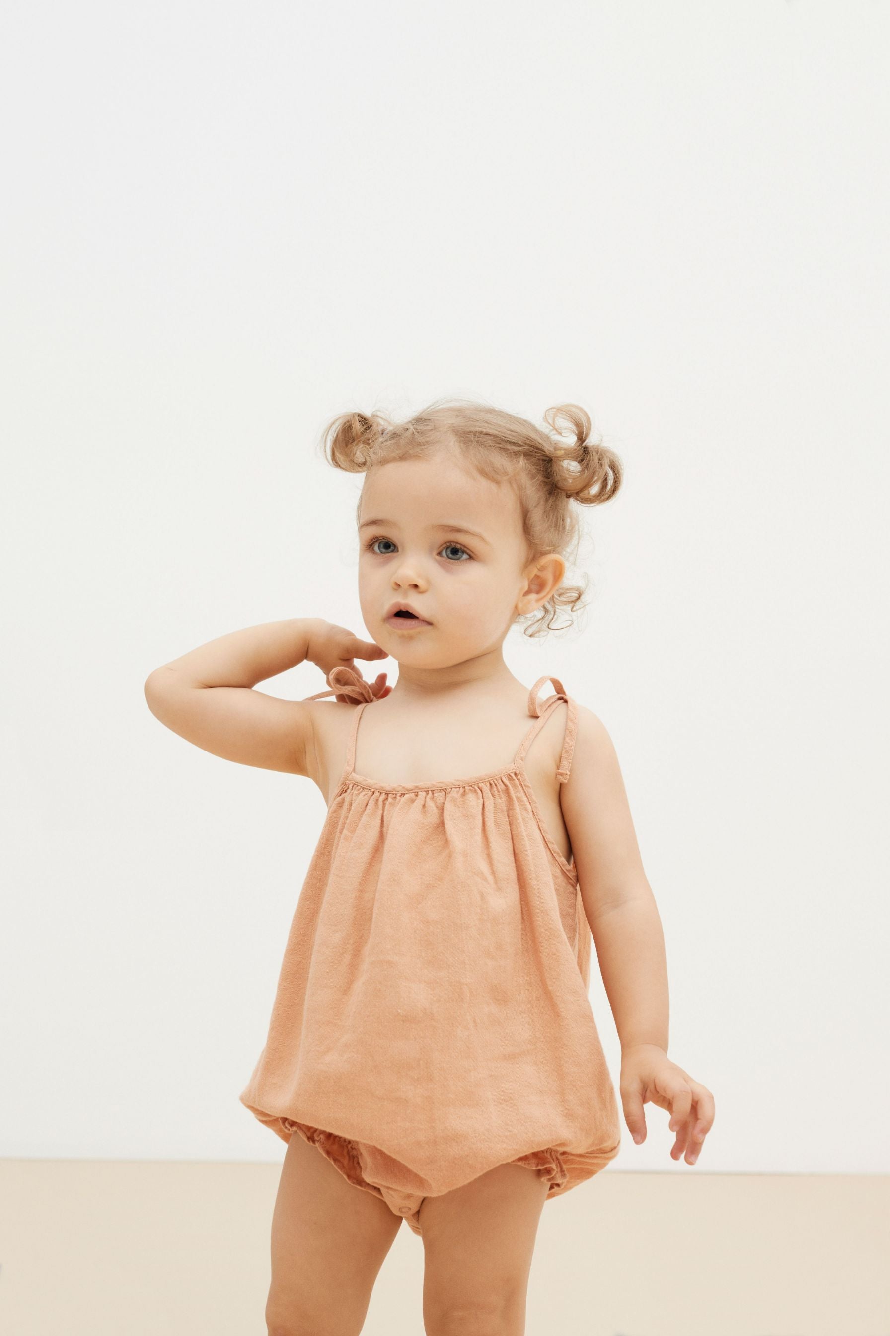 Light peach organic cotton baby girl summer romper is the most adorable outfit. The organic cotton baby romper is breathable, made with extra soft cotton. 
