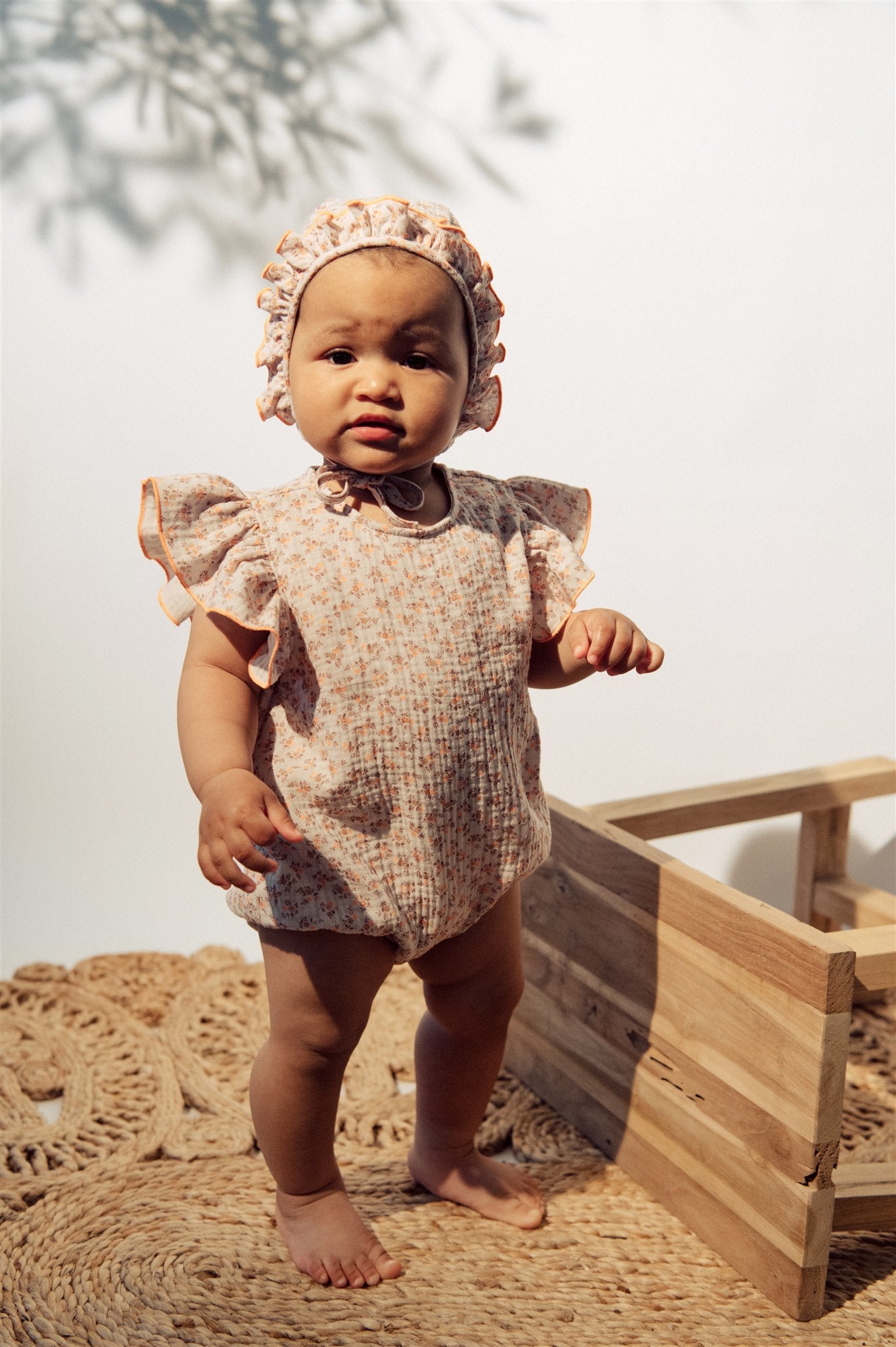 Baby girl sun hat with floral print and ruffles,  organic muslin with straps for secure fit and sun protection